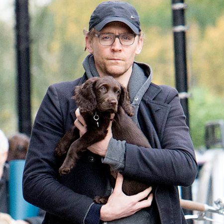 Tom Hiddleston carrying his pet